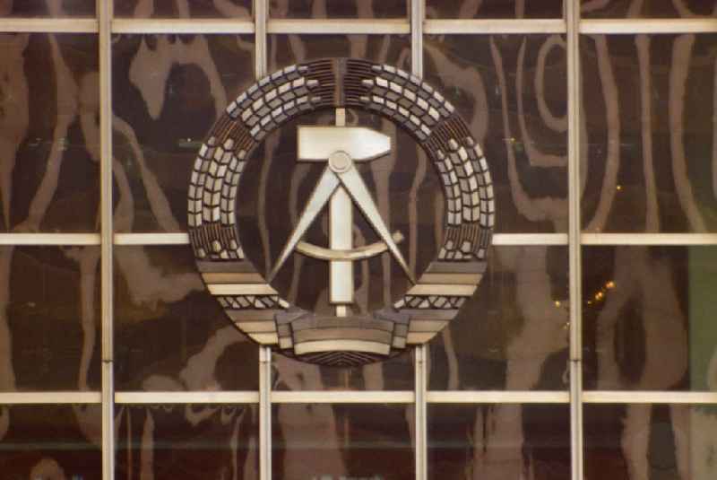 State coat of arms of the GDR, consisting of a wreath of ears of corn, hammer and compass, on the facade of the Palace of the Republic in East Berlin on the territory of the former GDR, German Democratic Republic