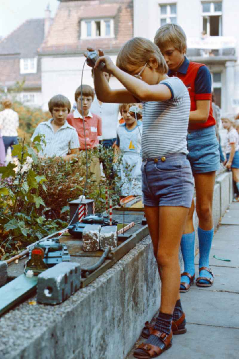 Boy plays with a toy tank at the Pankefest in East Berlin on the territory of the former GDR, German Democratic Republic