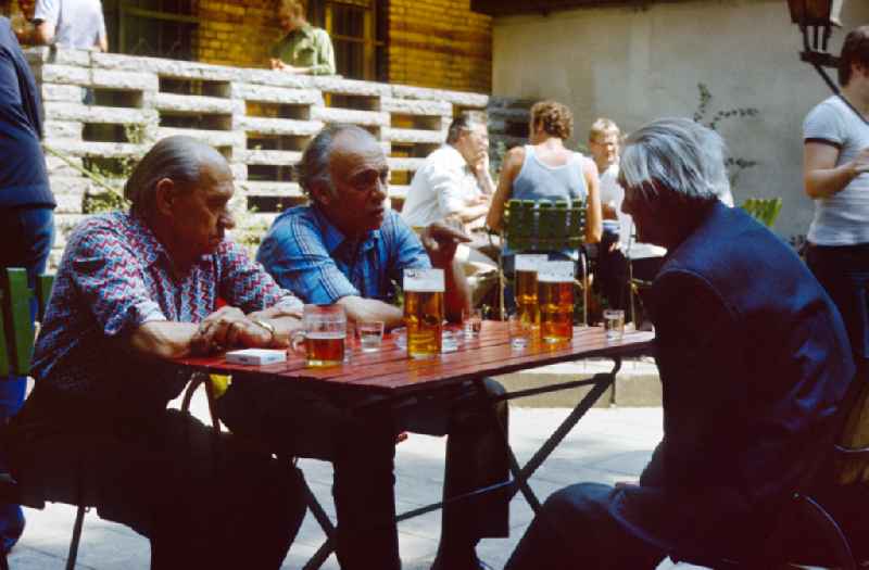 Men sit in a bar and drink beer in East Berlin on the territory of the former GDR, German Democratic Republic