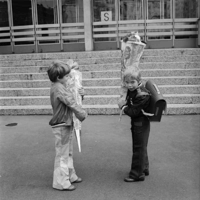 Two graders with their large cornet of cardboard before the entrance to the school in Berlin - Friedrichshain