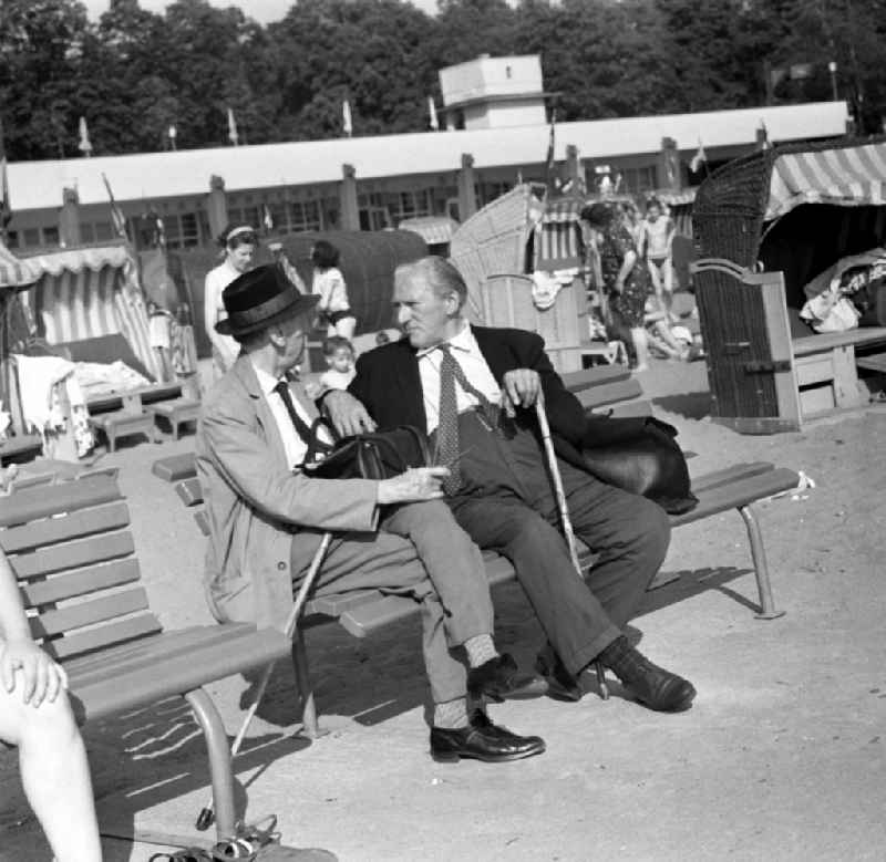 Two elderly men on a bench in beach Müggelsee in Berlin - Köpenick. The lido Müggelsee, also known as beach Rahn village is a swimming pool in Berlin-Rahn village on the north bank of the Müggelsee