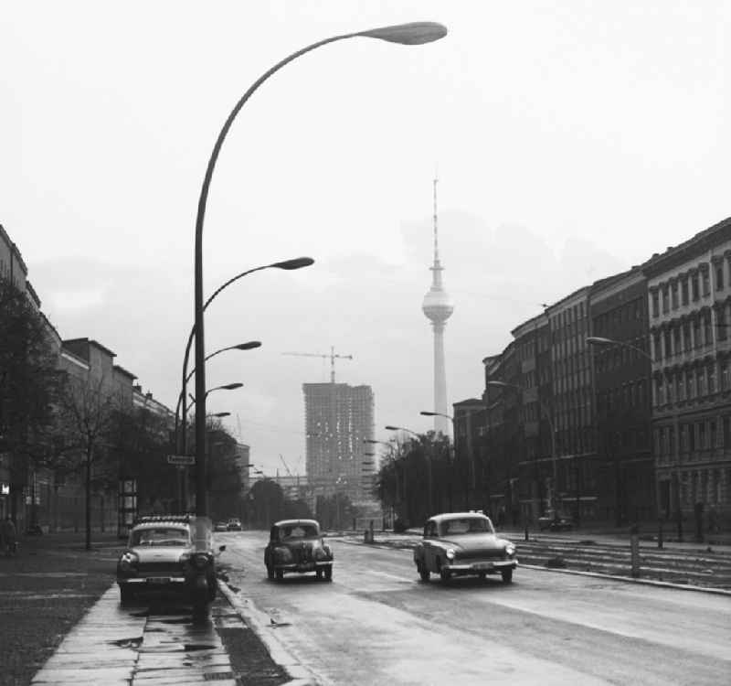 Cars of the Wartburg brand and F9 on the street. This view towards the Fersehturms and the site for the construction of the 'house of travel' near the Alexanderplatz