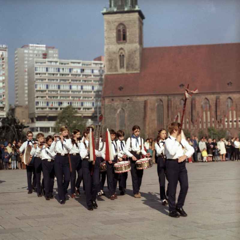 Fanfare of music corps of the Young Pioneers of the GDR pulls making music on the square between Karl-Liebknecht-Straße and Town Hall Street in the city center Mitte in Berlin
