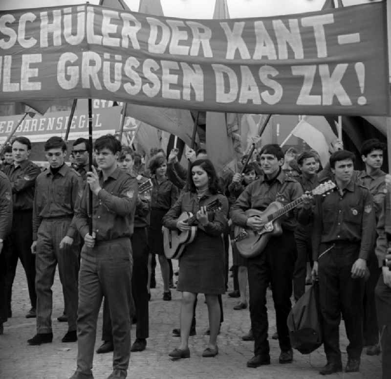 Enthusiastic students of Immanuel - Kant - EOS with flags, guitars, banners and slogans at the parading of the rostrum to the fight and the holiday of 1 On May Schlossplatz in Berlin - Mitte