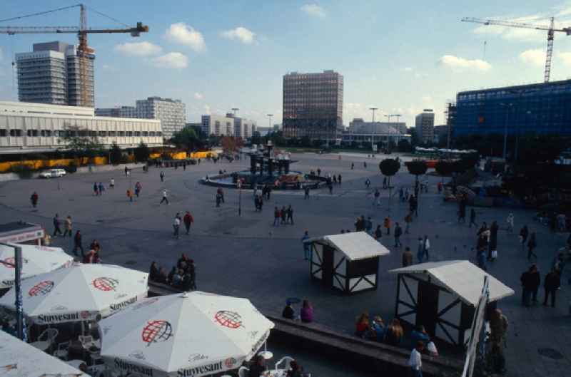 View of the Alexanderplatz in Berlin - Mitte. Around the square with the Fountain of International Friendship in the centre, there are the former House of Travelling, the Teacher's House, the congress hall and the former head office of the bank Sparkasse (from left to right)