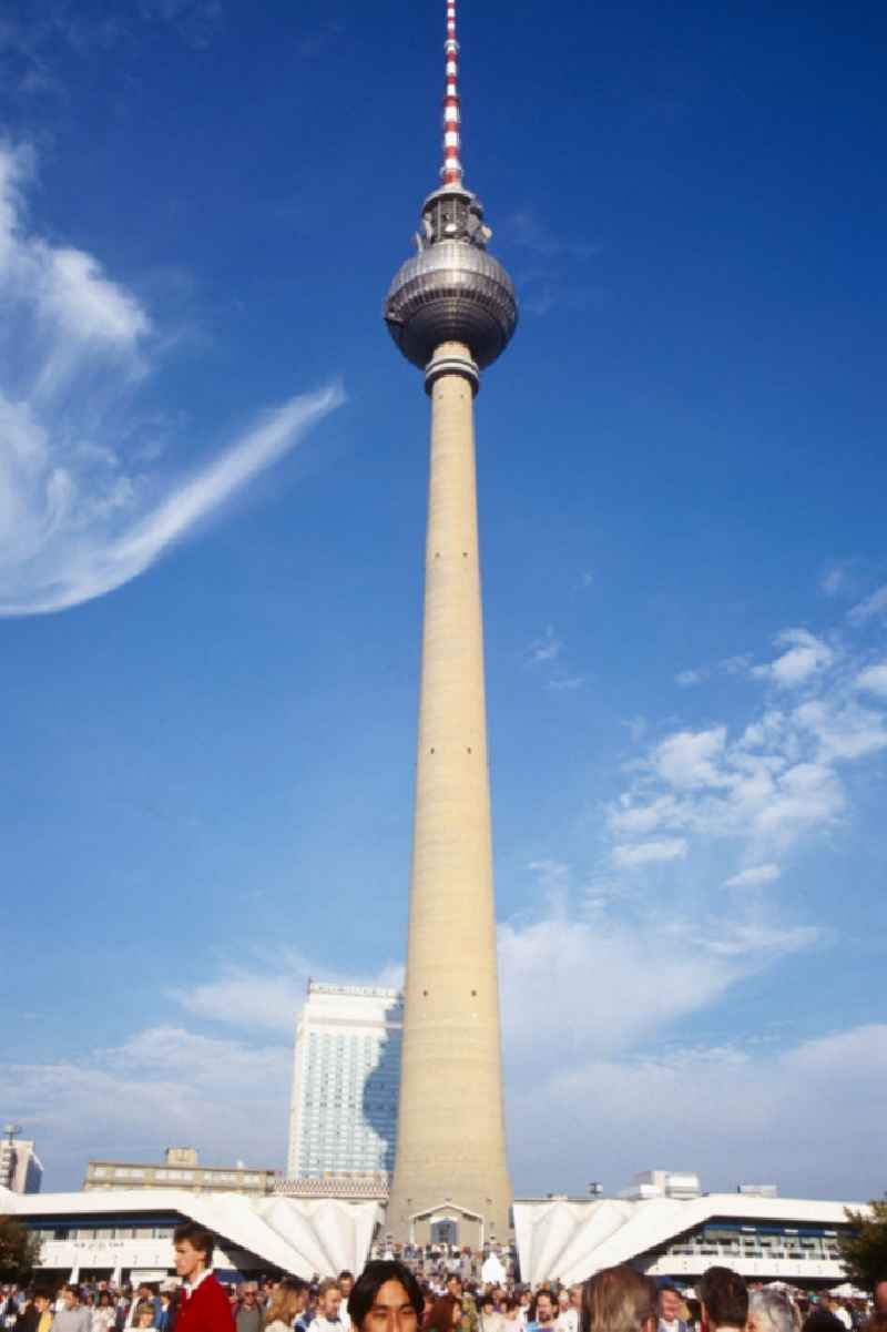 View of the TV Tower with the Hotel Stadt Berlin in the background in Berlin - Mitte. The Berlin TV Tower is the tallest building in Germany. As a politically simplistic ahmtes symbol of the GDR, the distinctive and influential city building has undergone a transition to the citywide icon in reunited Berlin