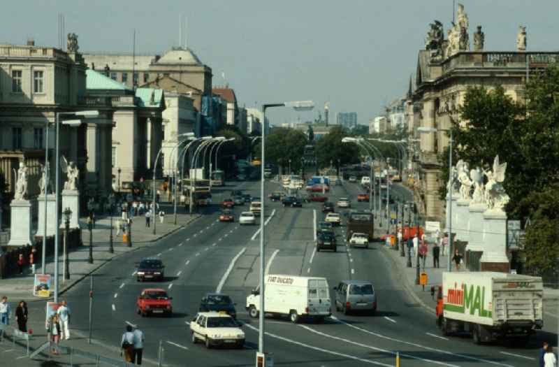 Unter den Linden with views towards the Brandenburg Gate in Berlin - Mitte with the 8 figures of Karl Friedrich Schinkel in marble at the castle bridge in the foreground. Links the German State Opera, Komische Oper and others. On the right the Museum of German History. In the middle of the road the equestrian statue of Frederick the Great