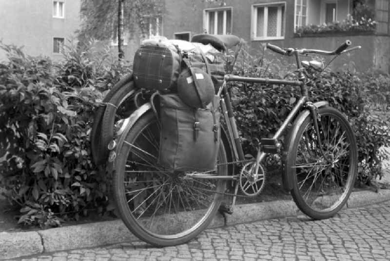 A men's bicycle is packed with Panniers on the edge of a sidewalk in Berlin