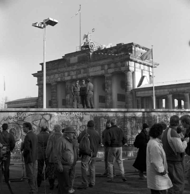 East German border guards on the wall in front of the Brandenburg Gate