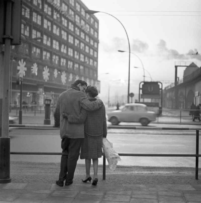 A couple in love with a bouquet of flowers in her hand at Alexanderplatz in Berlin - Mitte
