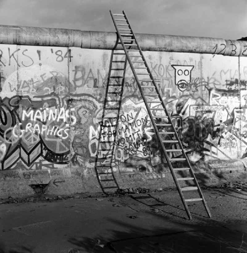 A wooden ladder leaning against the wall crown of the Berlin Wall in Berlin - Mitte