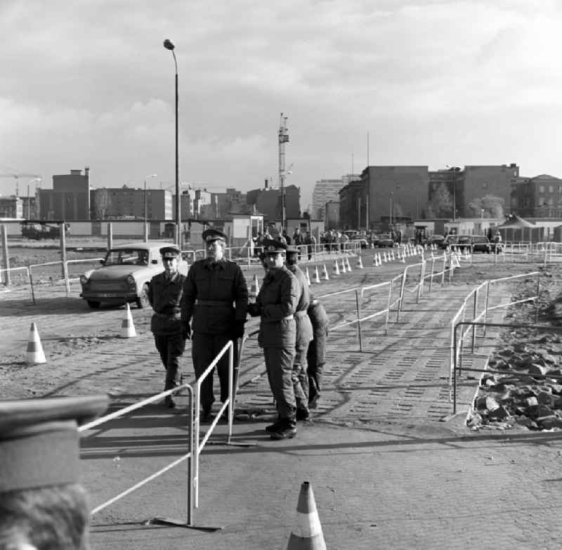 The provisional border crossing Potsdamer Platz in Berlin - Mitte. Soldiers of the Border Troops of the GDR are preparing for the beginning of the border traffic between East and West. Makeshift traffic cones were used to mark roadways