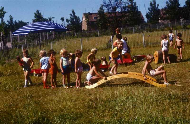 Children play in the garden of a daycare center in Bernau near Berlin in the state of Brandenburg on the territory of the former GDR, German Democratic Republic