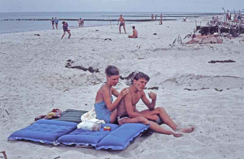 Vacationers and tourists as bathers on the sandy beachthe Baltic Sea in Born a. Darss, Mecklenburg-Western Pomerania on the territory of the former GDR, German Democratic Republic