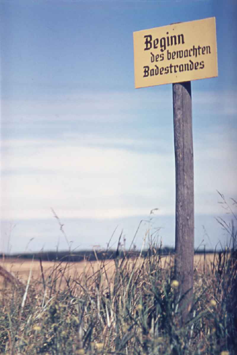 Warning of a sign 'Start of the guarded bathing beach' in Born a. Darss, Mecklenburg-Western Pomerania in the territory of the former GDR, German Democratic Republic