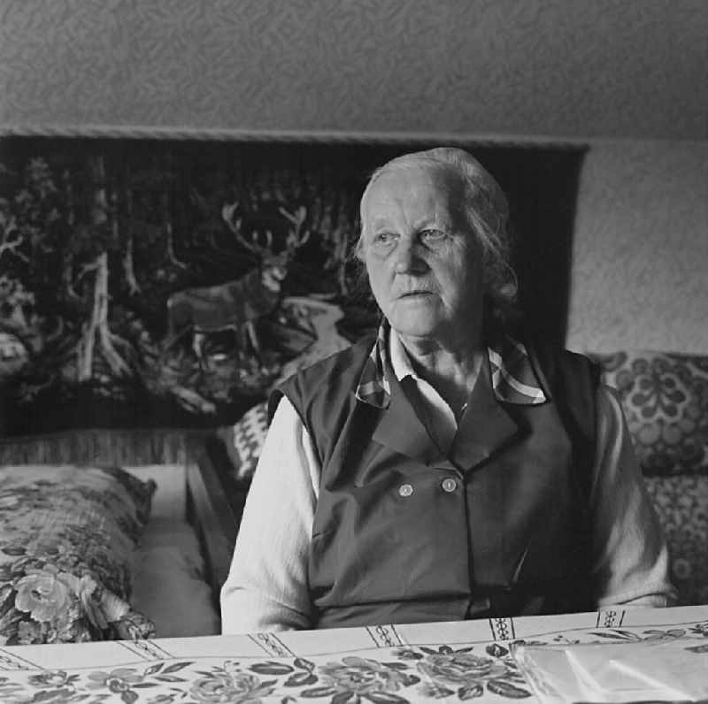 Portrait shot of an old Sorbian at the table in her living room in Burg (Spreewald), Brandenburg in the territory of the former GDR, German Democratic Republic