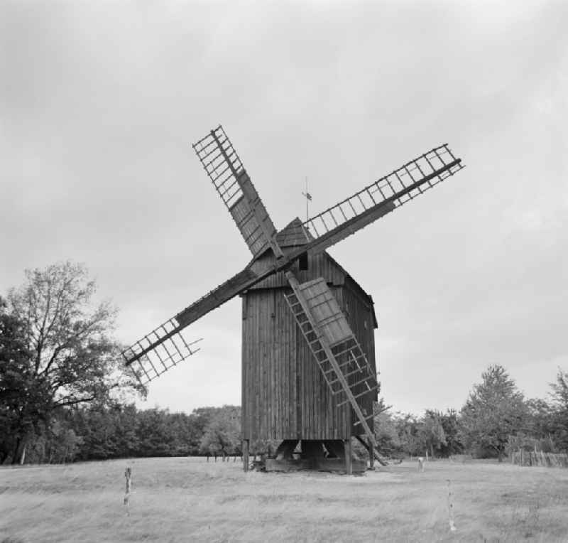 Windmill wings of a historic wooden windmillin a meadow in Crostwitz, Saxony on the territory of the former GDR, German Democratic Republic