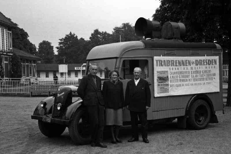 People standing in front of a Granit 25 loudspeaker truck at the Dresden-Seidnitz racecourse after in Dresden in the state Saxony on the territory of the former GDR, German Democratic Republic