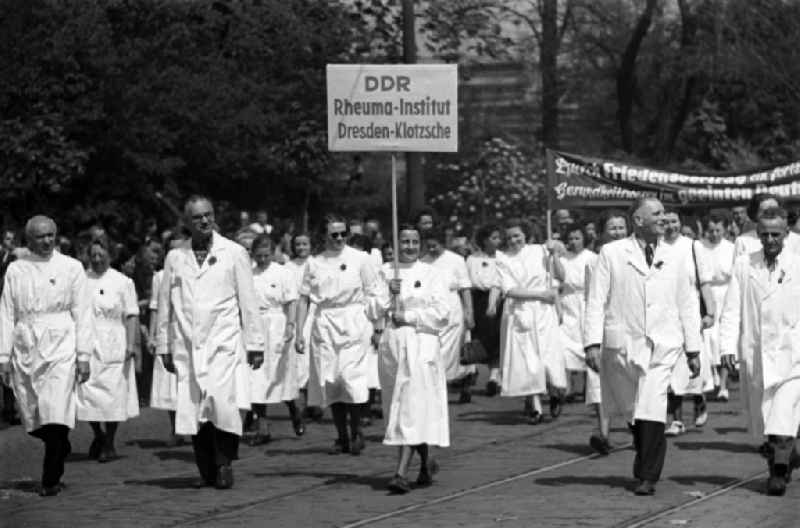 Medics, nurses and doctors from the Rheumatism Institute in white coats as participants in the May Day demonstration on the streets of the city center in the Altstadt district in Dresden, Saxony on the territory of the former GDR, German Democratic Republic