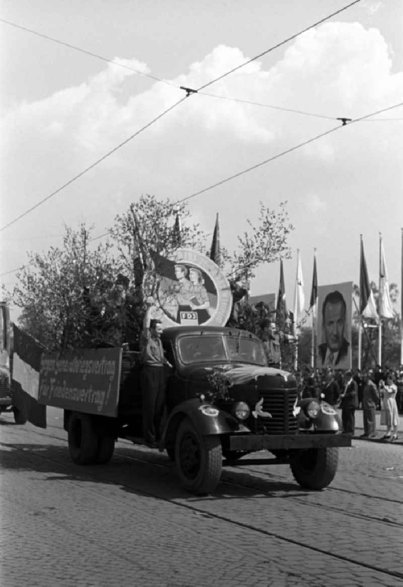 Protest poster and banner slogan 'Against a general war treaty for a peace treaty' carried by young members of the FDJ on a Russian truck in Dresden, Saxony on the territory of the former GDR, German Democratic Republic