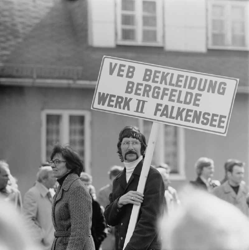 Participants to the May Day demonstration on the streets of the city center on street Finkenkruger Strasse in Falkensee, Brandenburg on the territory of the former GDR, German Democratic Republic