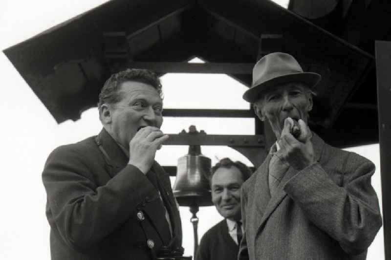 Men eat a Thuringian Rostbratwurst in Gotha in the state Thuringia on the territory of the former GDR, German Democratic Republic