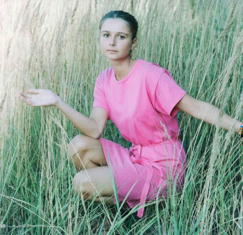 Young Woman on a meadow in Gruenheide (Mark) in Brandenburg in the area of the former GDR, German Democratic Republic