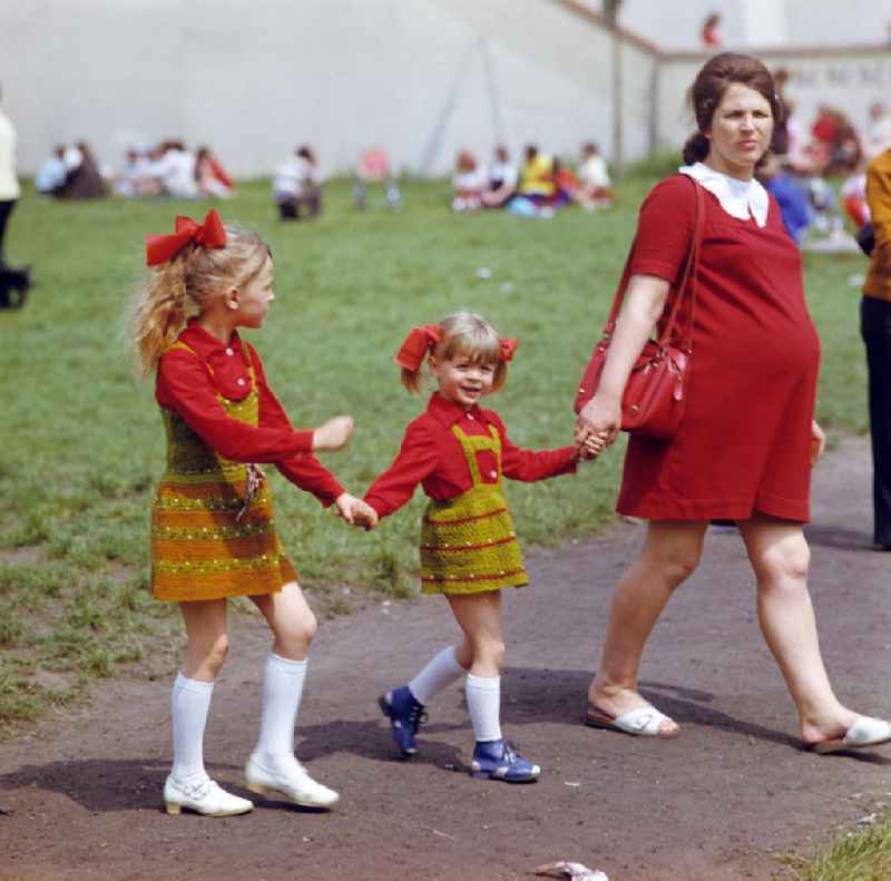 Eine schwangere Frau mit ihren zwei Mädchen mit selbstgestrickten Röckchen auf dem Frühlingsfest in Gubin.