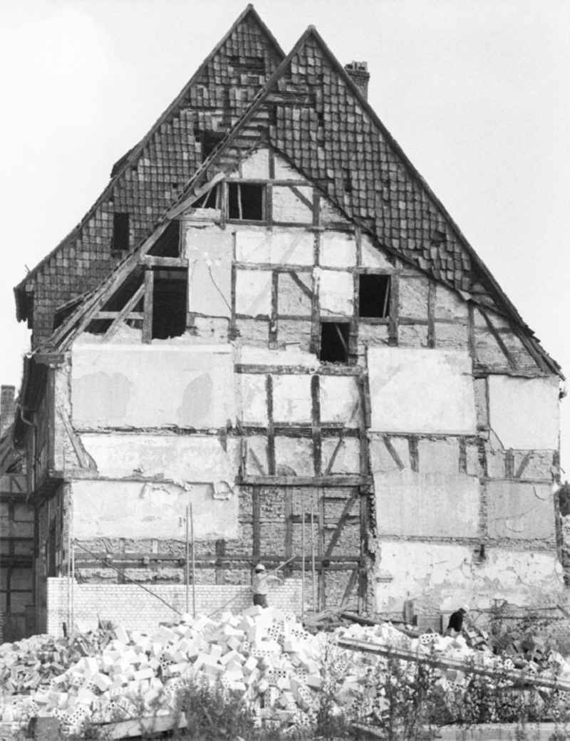 Rubble and ruins Rest of the facade and roof structure of the half-timbered house an der Groeperstrasse in Halberstadt in the state Saxony-Anhalt on the territory of the former GDR, German Democratic Republic