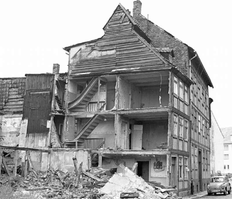 Rubble and ruins Rest of the facade and roof structure of the half-timbered house an der Ochsenkopfstrasse in Halberstadt in the state Saxony-Anhalt on the territory of the former GDR, German Democratic Republic