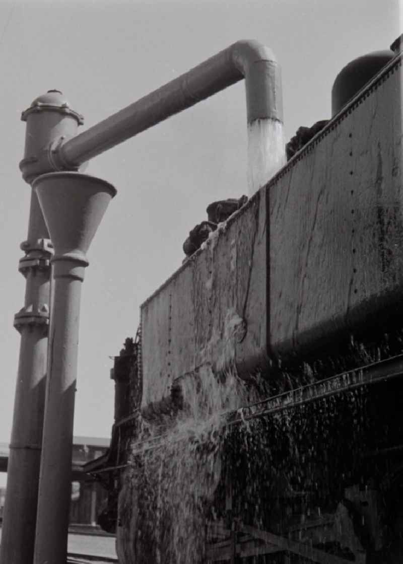 Filling at the water crane of a steam locomotive class 93 of the German Reichsbahn in Halberstadt in the federal state of Saxony-Anhalt on the territory of the former GDR, German Democratic Republic