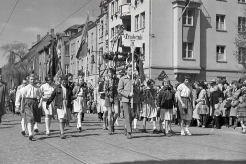 Participants des Umzuges on the struggle and celebration day of the working people on May 1st on the streets of the city center in Halberstadt in the state Saxony-Anhalt on the territory of the former GDR, German Democratic Republic