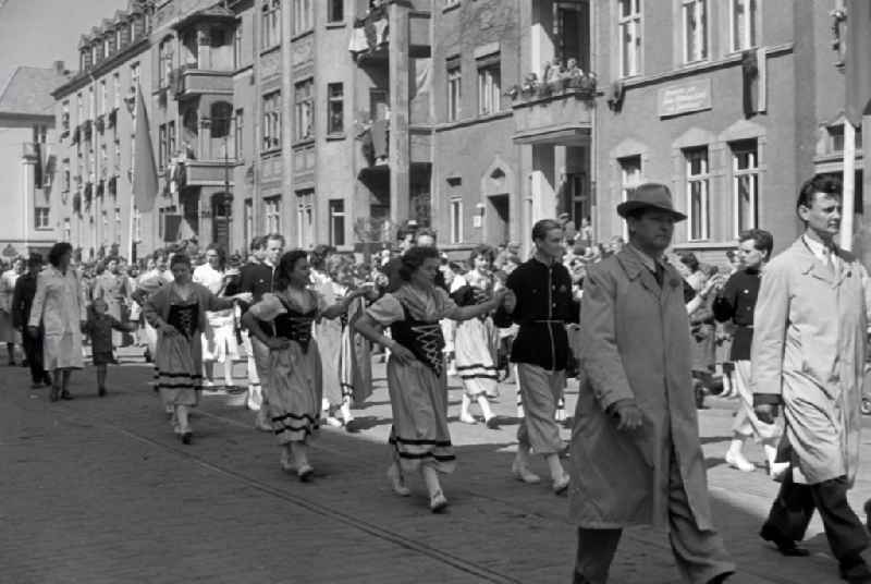 Participants des Umzuges on the struggle and celebration day of the working people on May 1st on the streets of the city center in Halberstadt in the state Saxony-Anhalt on the territory of the former GDR, German Democratic Republic
