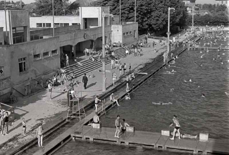 Bathers in the swimming pool and the outdoor facilities of the swimming pool Sommerbad an der Gebrueder-Rehse-Strasse in Halberstadt in the state Saxony-Anhalt on the territory of the former GDR, German Democratic Republic