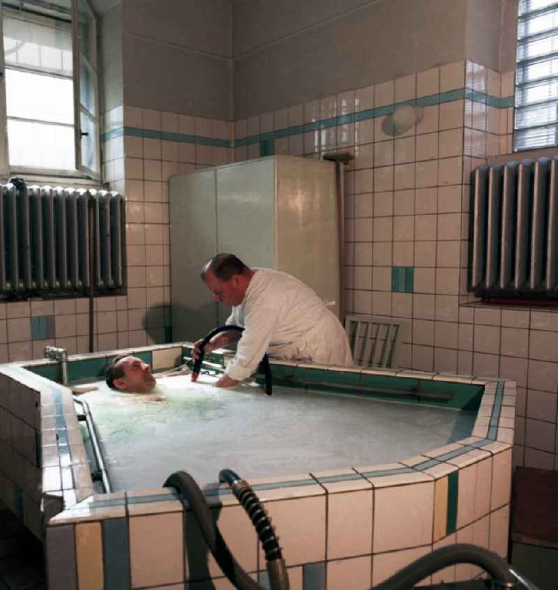 Patient during an application of physiotherapy in a medication tank in Halle-Neustadt