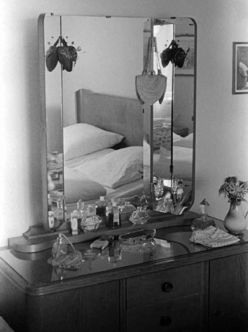 A dressing table with 3-part mirror, glass top and different perfume bottles in a bedroom in hall (hall) in the federal state Saxony-Anhalt in the area of the former GDR, German democratic republic