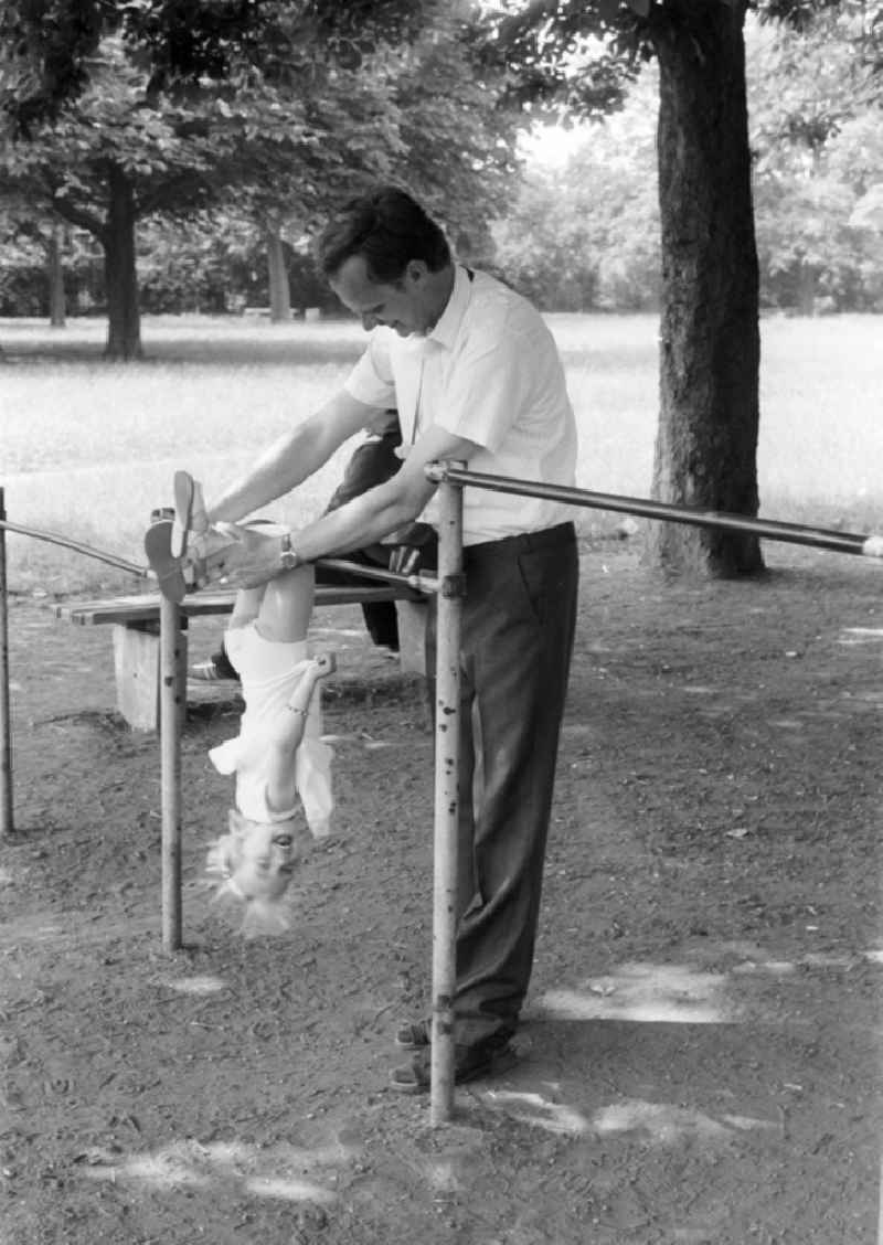 Father with child on a playground in Halle (Saale) in the federal state of Saxony-Anhalt on the territory of the former GDR, German Democratic Republic