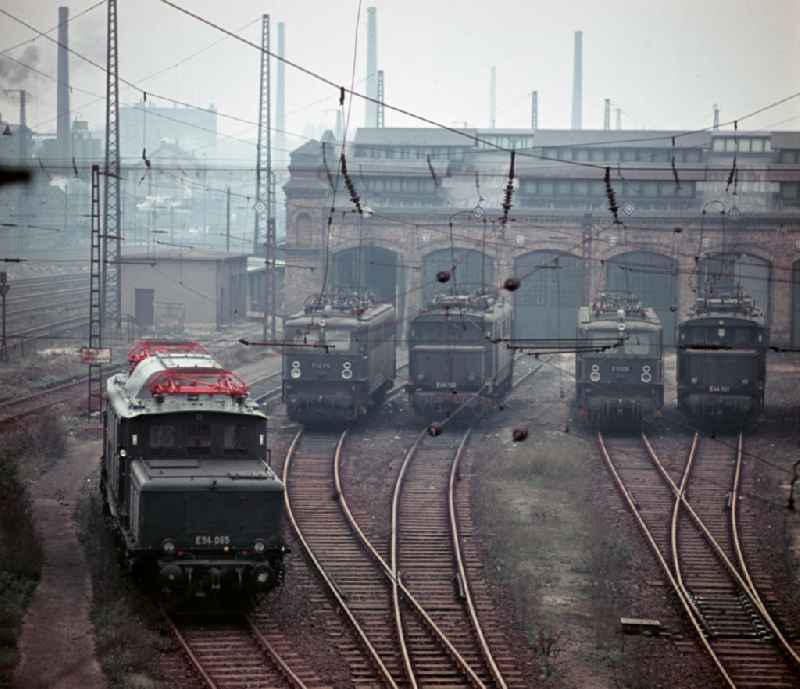 Work on the assembly of copper overhead lines - power lines on the rails and over the track systems on the railway line of the DR 'Deutsche Reichsbahn' on the outskirts in Halle (Saale) in the state Saxony-Anhalt on the territory of the former GDR, German Democratic Republic