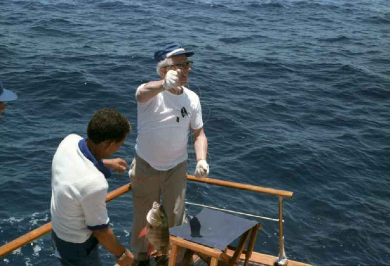 Enduring fishing by GDR State Council Chairman Erich Honecker and the Secretary of the Central Committee of the Communist Party of Cuba Fidel Alejandro Castro Ruz on a state yacht as part of the cultural context of an official state visit to Havana in Cuba