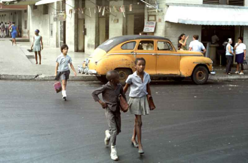 Schulkinder überqueren eine Straße in Havanna.