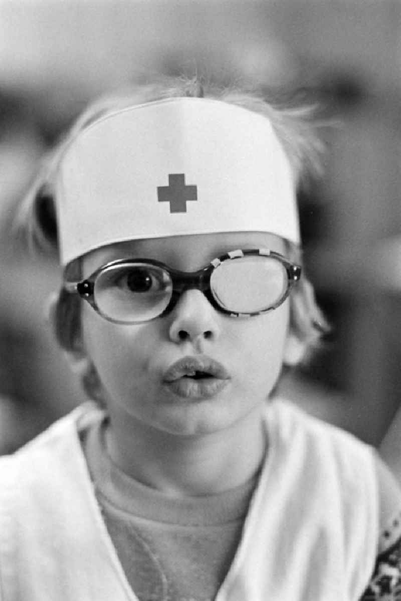 Child with headgear dressed as a nurse in the children's combination / in the kindergarten 'Puenktchen' in Hennigsdorf on the territory of the former GDR, German Democratic Republic