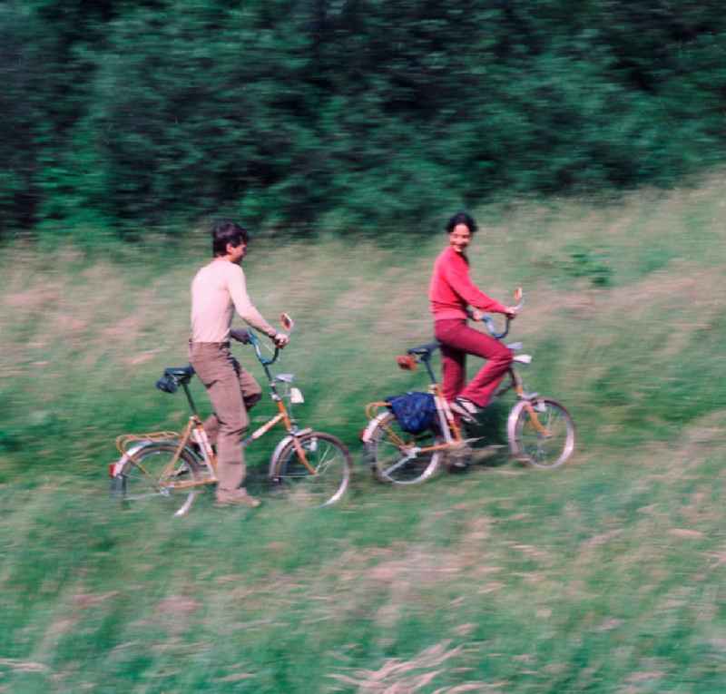 Young couple on folding bikes on the road in the countryside in Hohen Neuendorf in Brandenburg today