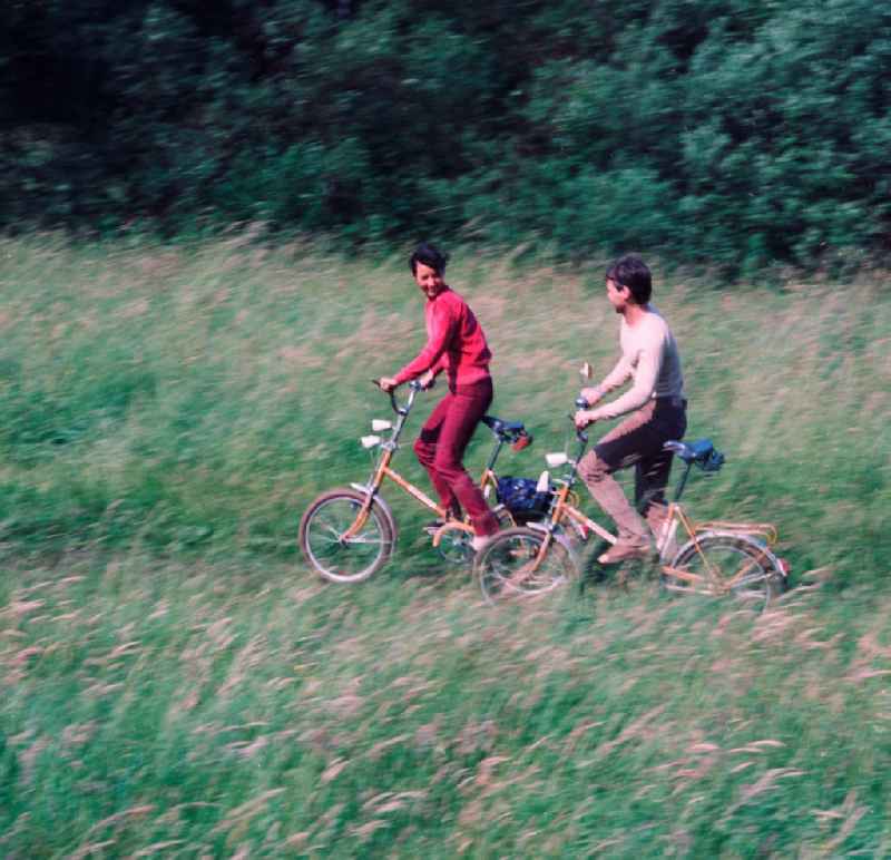Young couple on folding bikes on the road in the countryside in Hohen Neuendorf in Brandenburg today