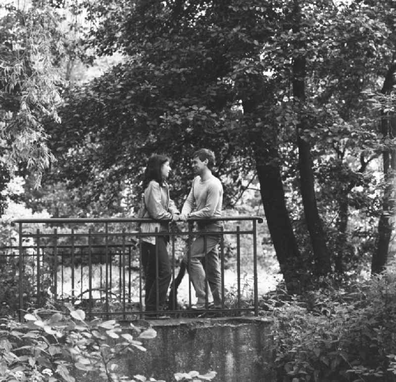 Young couple standing on a bridge in Hohen Neuendorf in Brandenburg today