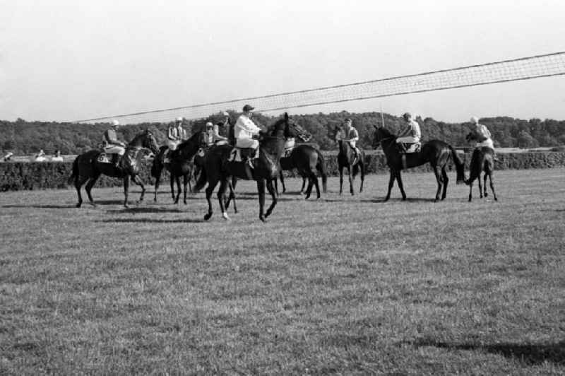 Horses and jockeys before the start of a gallop race in Hoppegarten in the state Brandenburg on the territory of the former GDR, German Democratic Republic