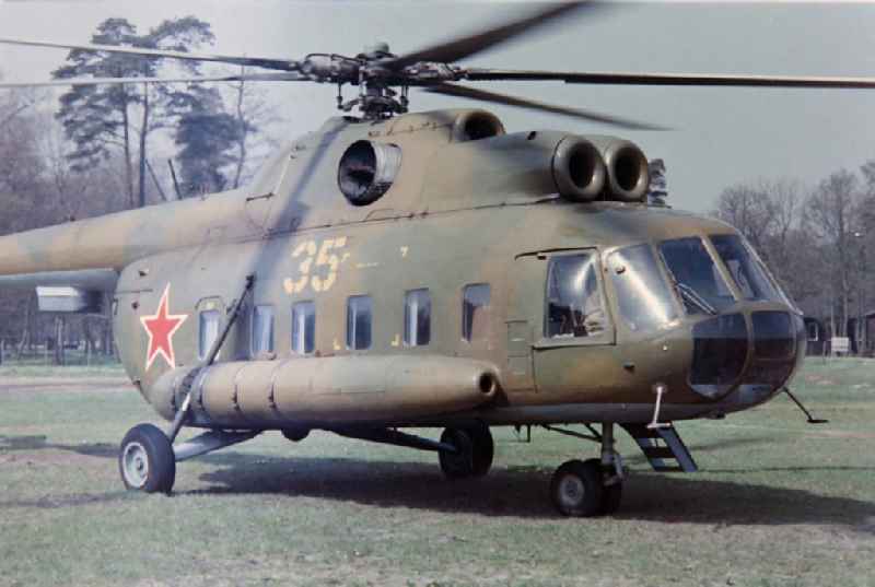 Military variant of the Mil Mi-8 helicopter of the GSSD 'Group of Soviet Forces in Germany' in the saloon variant on the sports field of the NVA office of the LSK/LV Air Force - Air Defense in Karlshagen in the state of Mecklenburg-Western Pomerania on the territory of the former GDR, Germans Democratic Republic