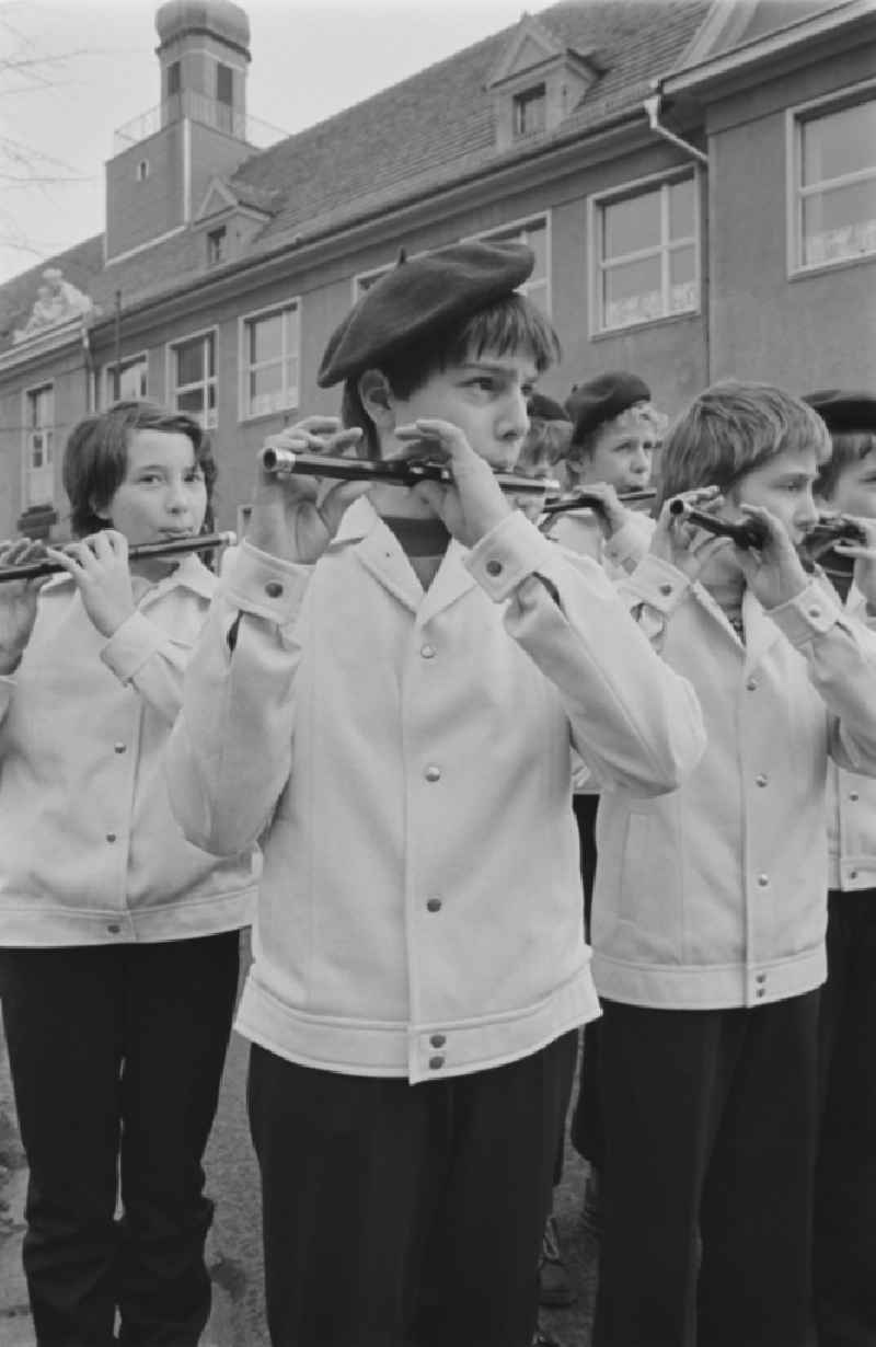 Secondary School OS Dr. Richard Sorge at Laubuscher Markt in the Upper Lusatian workers settlement Gartenstadt Erika in Laubusch in the state of Saxony on the territory of the former GDR, German Democratic Republic. Marching Band / minstrels play in uniform with their instruments in front of the school building