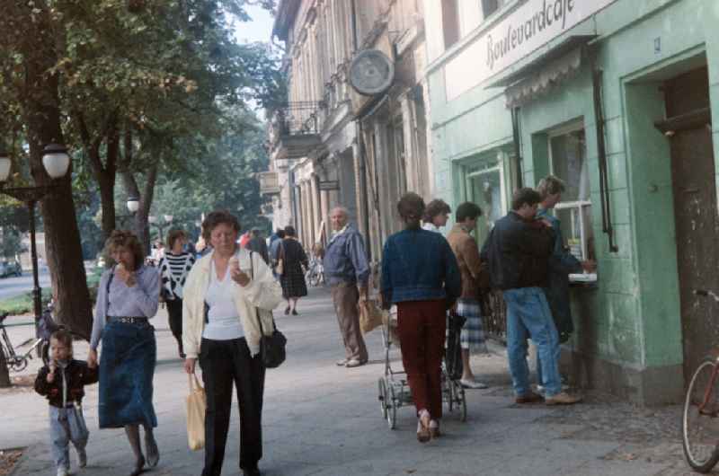 Pedestrians and passers-by in traffic in the inner city area in Luebben (Spreewald) in Lusatia, Brandenburg in the territory of the former GDR, German Democratic Republic