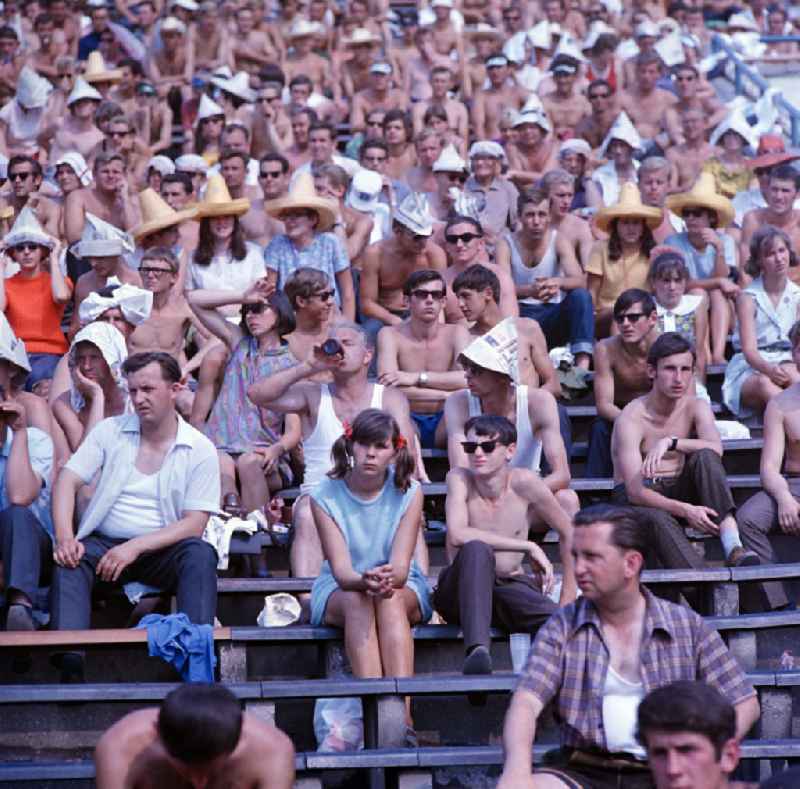Spectators sit in the stands in Leipzig's Central Stadium during the V. Gymnastics and Sports Festival of the GDR from 24 to 27