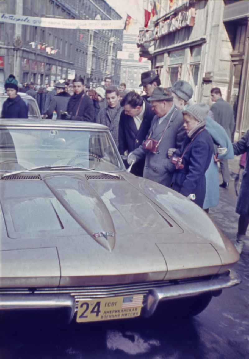 Motor vehicle of the western allied American MVM military liaison mission is admired by locals on the street Klostergasse in Leipzig in GDR
